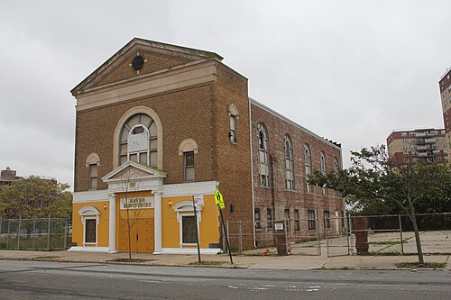 The Temple of Israel building on Beach 84th Street, brown brick with a stone pediment. The front now has a Haven Ministries sign and there are Stars of David in the window grilles.