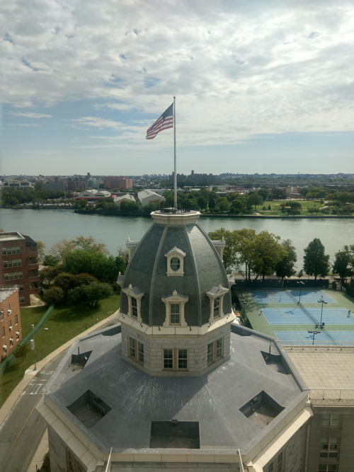 The Octagon's slate dome and lantern seen from above, with the East River and Queens behind it.
