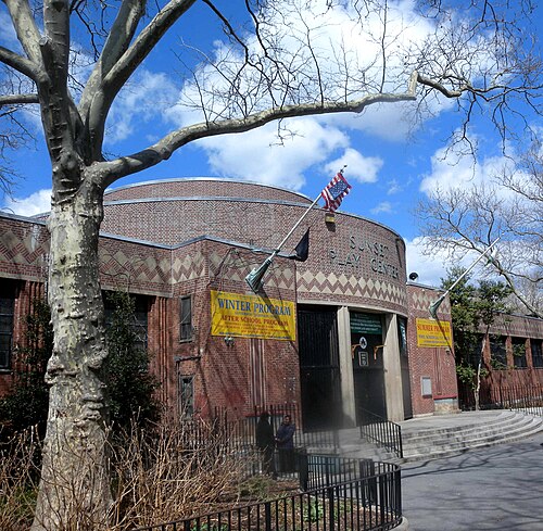 The Sunset Play Center of 1936, a round ended brick building with its name cut into the brickwork above the door.