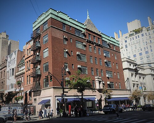 872 Madison Avenue at 71st Street, red brick with a green copper cornice and a conical turret on the corner, shops in the ground floor.