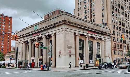 The former East River Savings Bank at Amsterdam Avenue and West 96th Street, a limestone front with Ionic columns and drugstore signs hung between them.