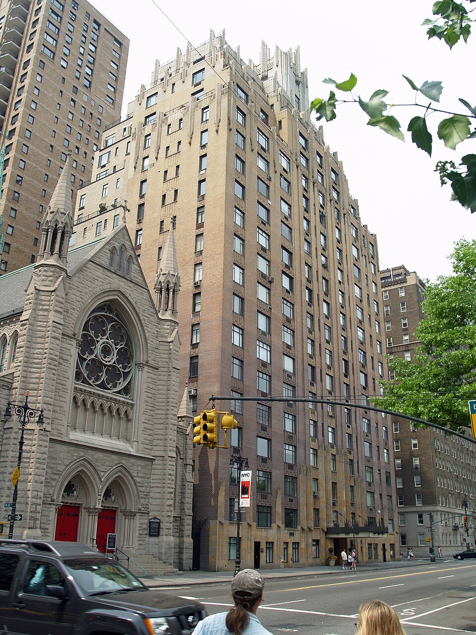 55 Central Park West looking north across West 65th Street, the brick going from dark at the bottom to pale at the top, with Holy Trinity Lutheran Church beside it.