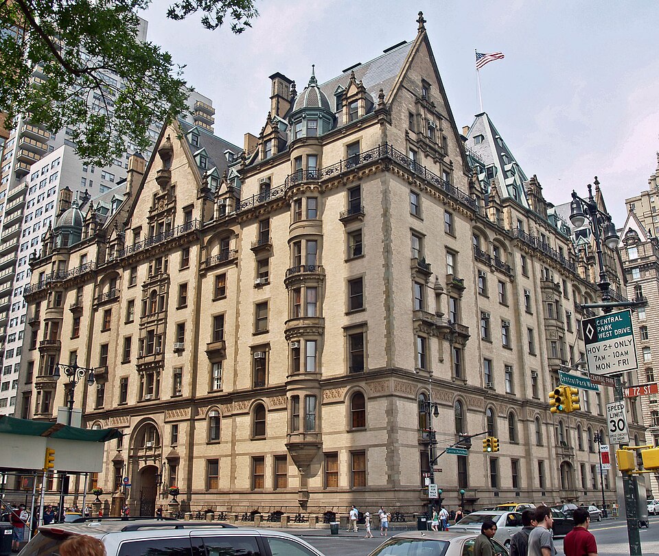 The Dakota on the corner of Central Park West and West 72nd Street, gables and dormers along the roof and the carriage arch at the left of the front.