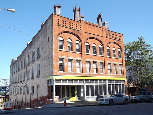 The Hubbard Cooke Building, a four storey brick warehouse with arched upper windows on Superior Viaduct.