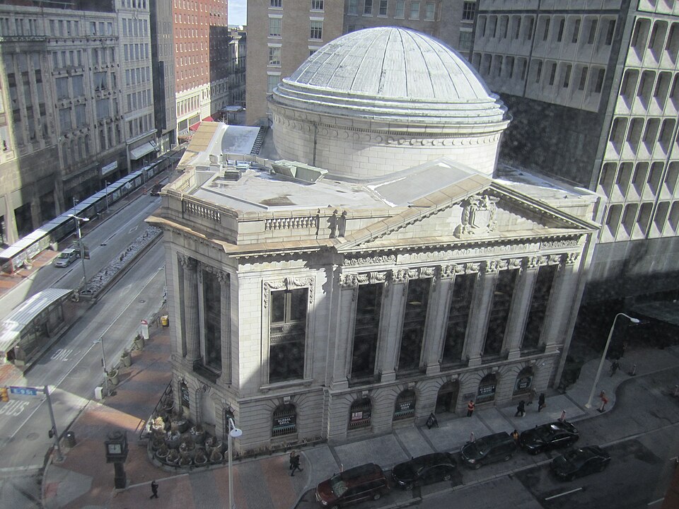 An aerial view of the domed Cleveland Trust Company building at Euclid Avenue and East 9th Street, its stone rotunda and copper dome distinct from the modern towers around it.