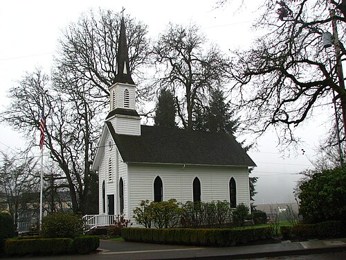 St. John's Episcopal Church, a white wood-frame chapel with a peaked steeple and lancet windows, near Sellwood Park.