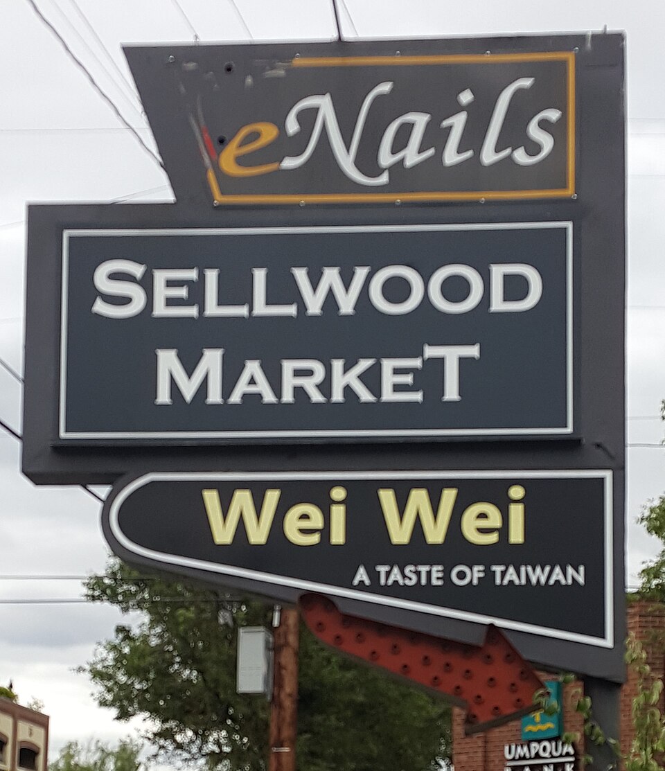 The stacked sign for Sellwood Market and the Wei Wei restaurant inside it, on SE 13th Avenue.