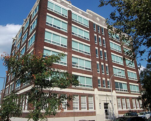 The six storey brick and terra cotta Boekel Building on Vine Street, rows of steel factory windows and a carved name plate over the entrance.