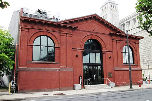 The red brick former High Pressure Fire Service pump house at Race Street, arched windows and a carved pediment, now used as a performance hall.