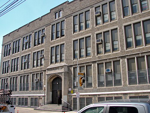 The stone and brick front of Richmond School on Belgrade Street, an arched entrance under a carved name plate.