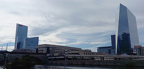 The Cira Centre's glass diamond and the FMC Tower across the Schuylkill, with 30th Street Station's colonnade at the waterline.
