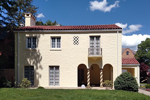 A stucco Mediterranean Revival house on Bigelow Boulevard, with a red tile roof and spiral porch columns.