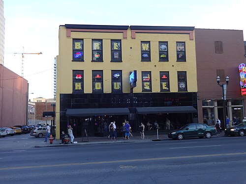 A two storey painted brick front on the 300 block, the word BREWHOUSE spelled out across the upper windows and the ground floor open behind black awnings.