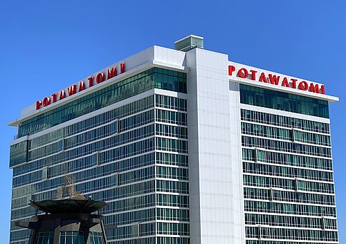 The Potawatomi Hotel's white and glass tower, POTAWATOMI in red capital letters along the top on both faces.